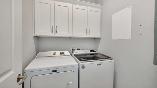 laundry area featuring cabinets and washing machine and clothes dryer