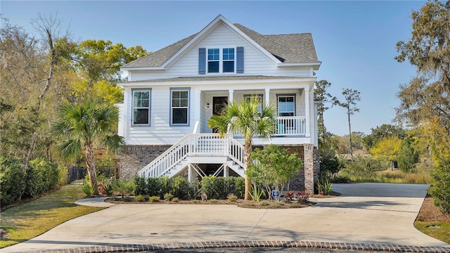 beach home featuring covered porch