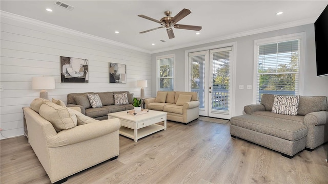 living room with ceiling fan, a healthy amount of sunlight, crown molding, and light hardwood / wood-style flooring