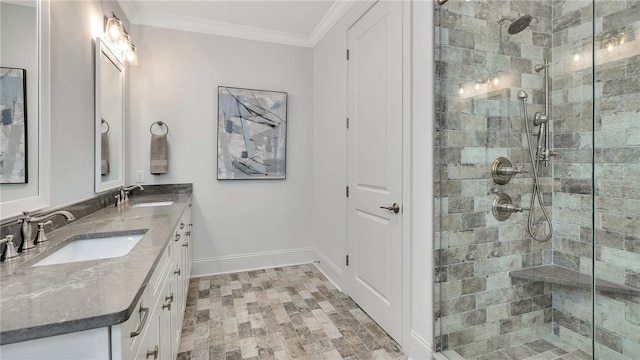 bathroom with crown molding, vanity, and tiled shower