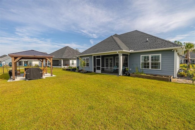 69 Allie Loop, Brunswick, GA 31525 - rear view of property with a gazebo, a sunroom, a yard, a patio area, and roof with shingles