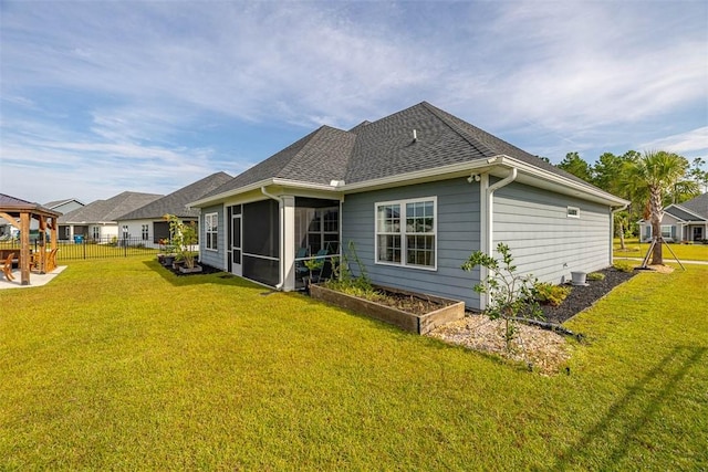 69 Allie Loop, Brunswick, GA 31525 - back of property with a sunroom and roof with shingles