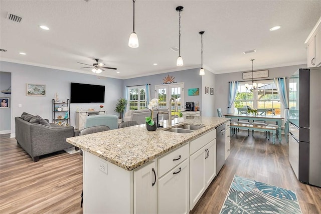 69 Allie Loop, Brunswick, GA 31525 - kitchen with freestanding refrigerator, ornamental molding, dishwasher, ceiling fan, and white cabinetry