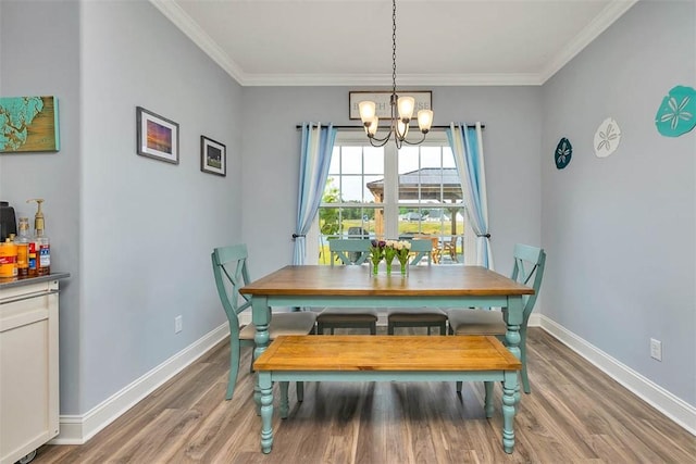 69 Allie Loop, Brunswick, GA 31525 - dining room featuring a chandelier, wood finished floors, and ornamental molding