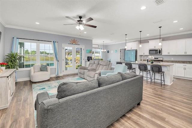 69 Allie Loop, Brunswick, GA 31525 - living room with light wood finished floors, ceiling fan, recessed lighting, crown molding, and a water view