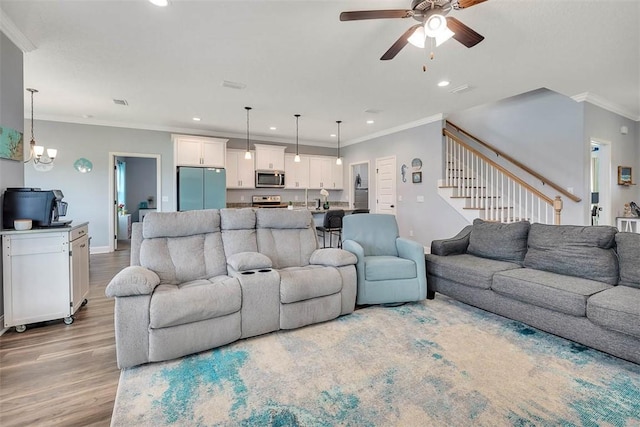 69 Allie Loop, Brunswick, GA 31525 - living room with recessed lighting, light wood finished floors, ceiling fan, ornamental molding, and stairs