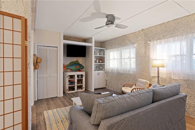 living area featuring ceiling fan and wood finished floors