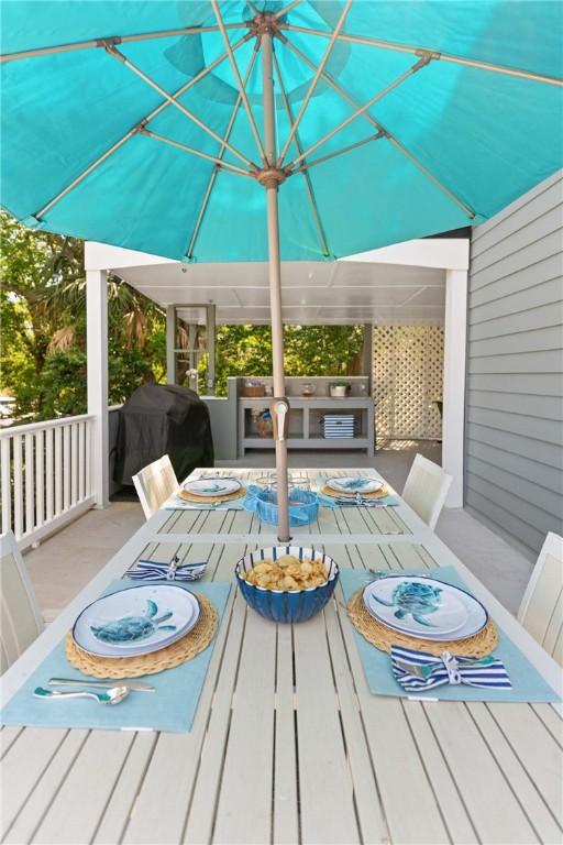 deck with outdoor dining area, an outdoor kitchen, and area for grilling