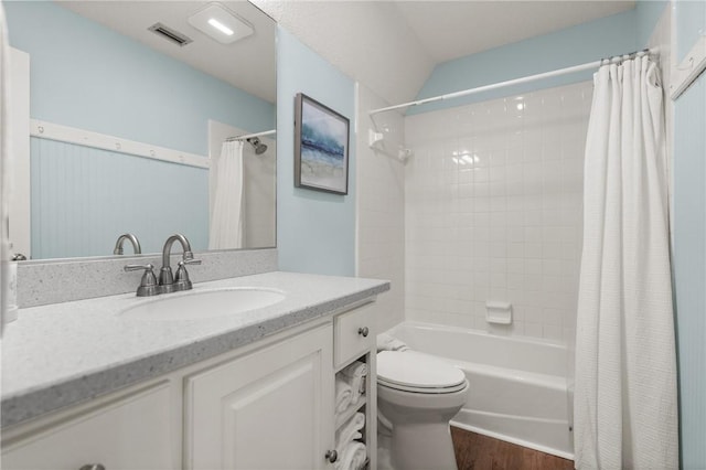bathroom with vanity, shower / bath combo with shower curtain, toilet, wood finished floors, and visible vents