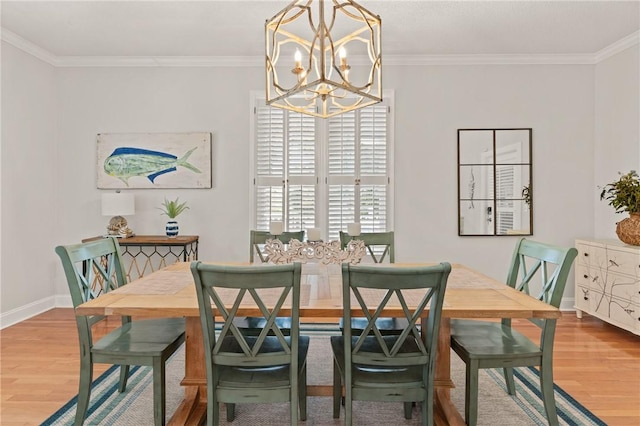 dining area with an inviting chandelier, ornamental molding, baseboards, and wood finished floors