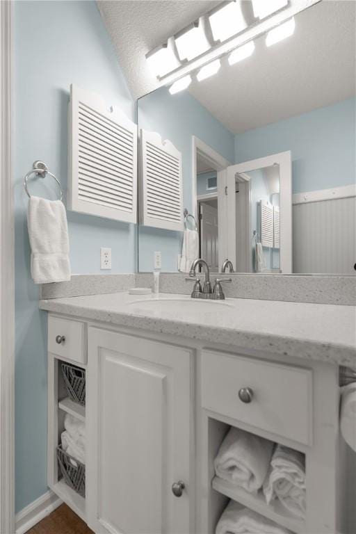bathroom with vanity and a textured ceiling