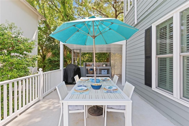 view of patio with outdoor dining area and grilling area