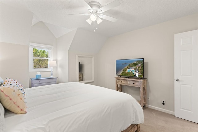 bedroom featuring baseboards, a textured ceiling, lofted ceiling, and light carpet