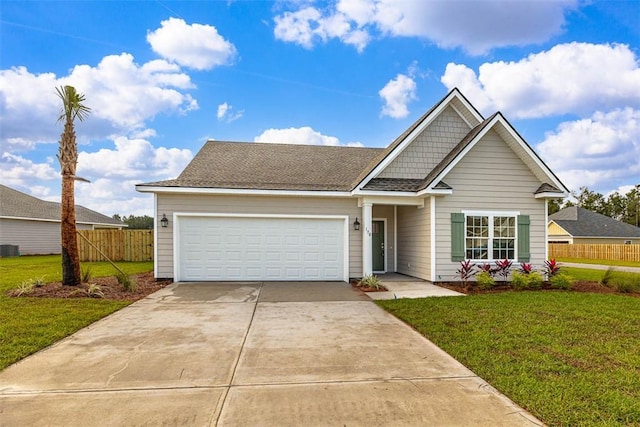 view of front of home with a front yard, a garage, and central AC unit