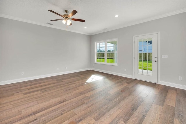 spare room featuring crown molding, ceiling fan, a textured ceiling, and light wood-type flooring