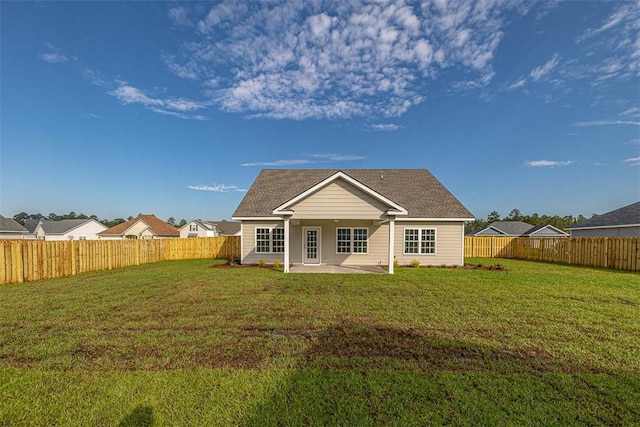 back of property featuring a patio area and a yard