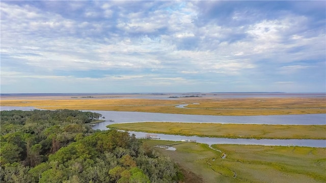 aerial view with a wooded view and a water view