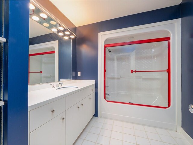 bathroom featuring baseboards, tile patterned floors, vanity, and shower / washtub combination