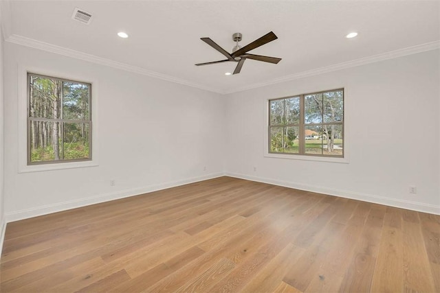 spare room featuring ornamental molding, ceiling fan, and light wood-type flooring