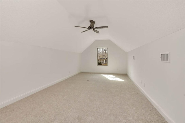 additional living space featuring light carpet, vaulted ceiling, and ceiling fan