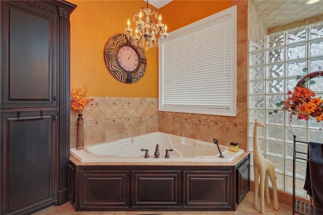 bathroom with an inviting chandelier, a bath, and tile patterned flooring