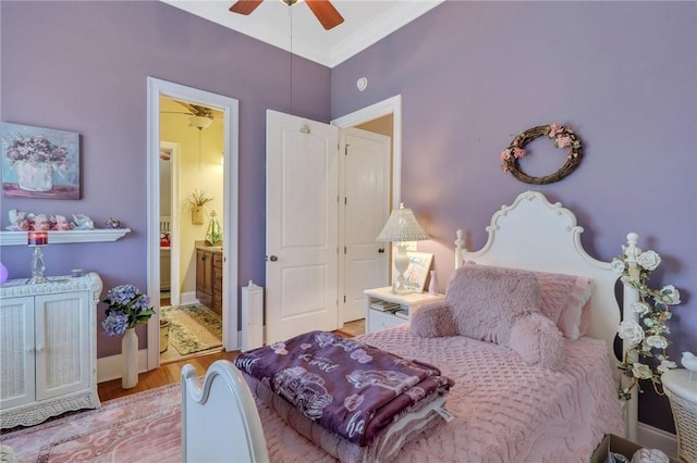 bedroom with light wood-style floors, baseboards, ensuite bathroom, and ceiling fan