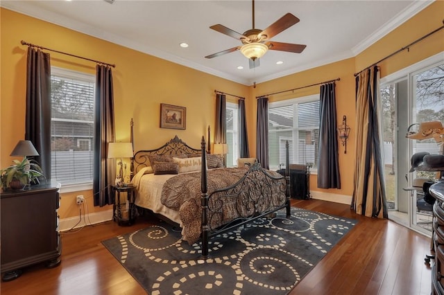 bedroom with multiple windows, wood finished floors, crown molding, and access to outside