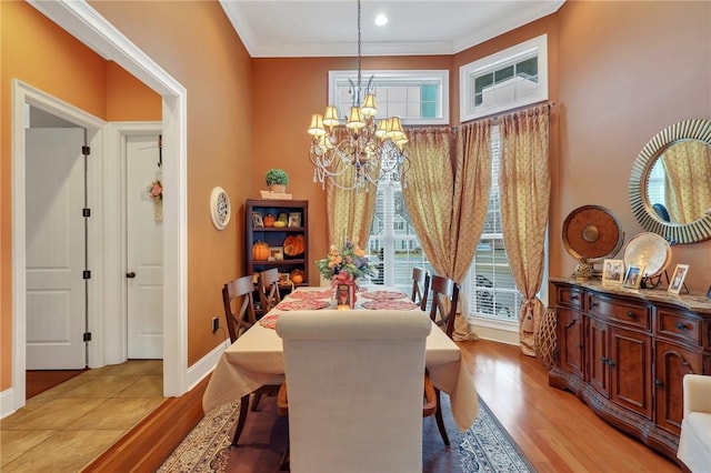 dining area featuring a wealth of natural light, light wood-style floors, and an inviting chandelier