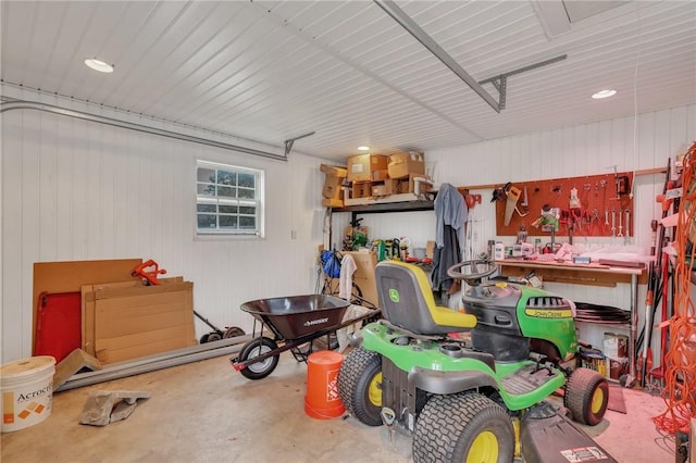 garage with a workshop area and metal wall