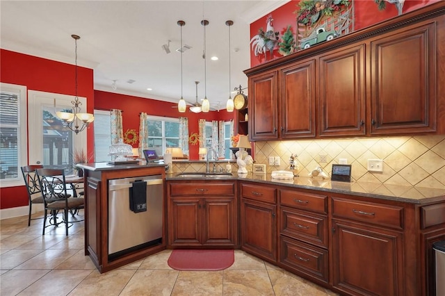 kitchen featuring a peninsula, a sink, decorative backsplash, stainless steel dishwasher, and a notable chandelier