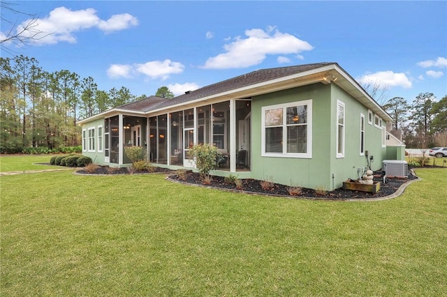 rear view of property featuring stucco siding, cooling unit, a yard, and a sunroom