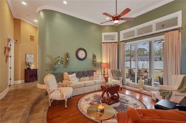 living room featuring crown molding, recessed lighting, baseboards, and ceiling fan