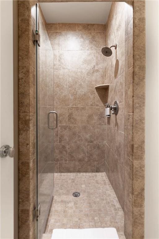 bathroom featuring a shower with door