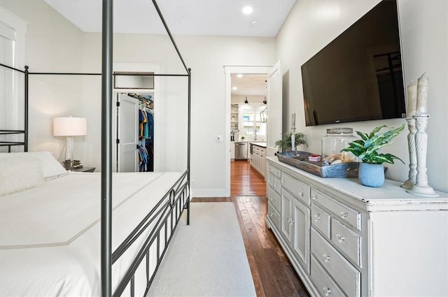 bedroom with a closet and dark wood-style flooring