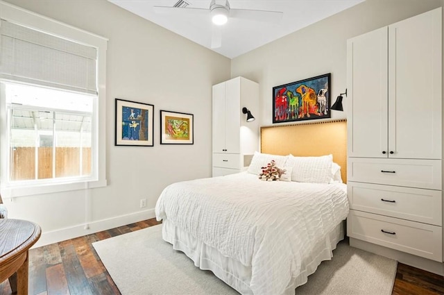 bedroom with baseboards, dark wood-type flooring, and ceiling fan