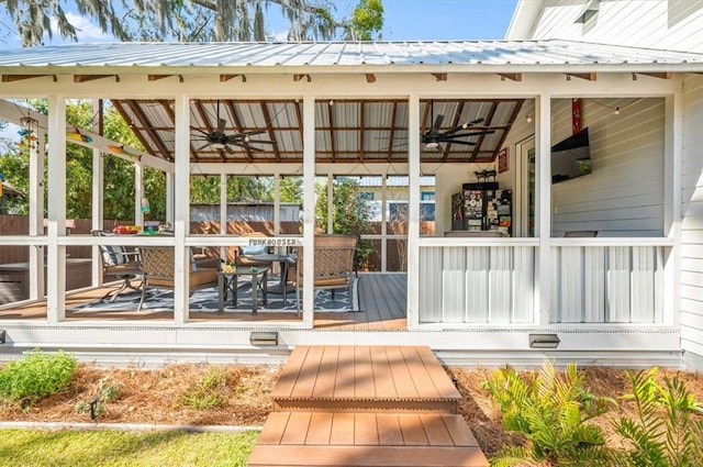 wooden terrace with a porch, ceiling fan, and fence