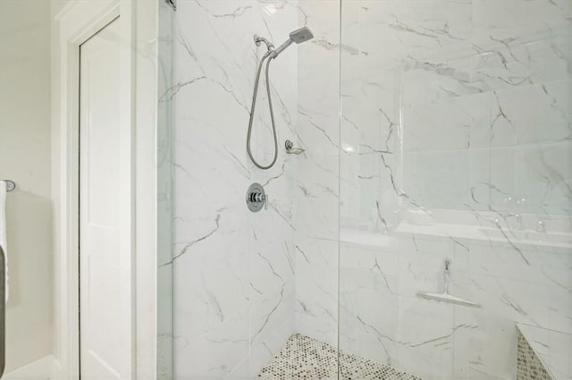 full bathroom featuring a marble finish shower