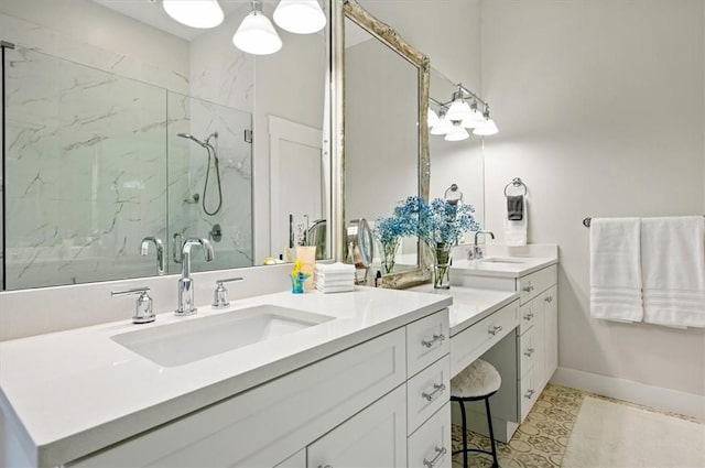 full bath with vanity, baseboards, and a marble finish shower