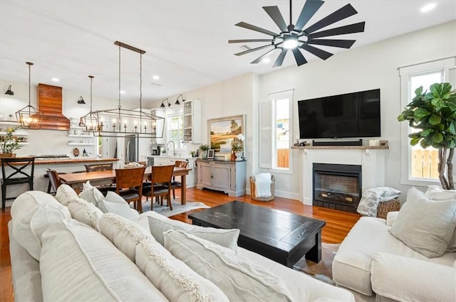 living area featuring plenty of natural light, light wood-style floors, and recessed lighting