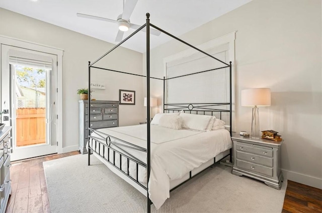 bedroom with access to exterior, a ceiling fan, baseboards, and wood-type flooring