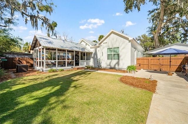 back of house with a lawn and fence