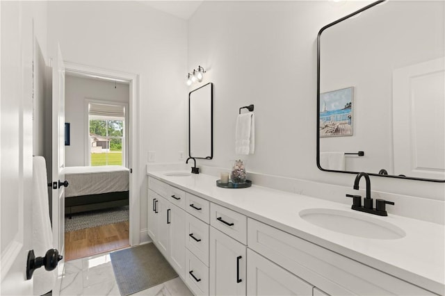 full bathroom with double vanity and ensuite bathroom