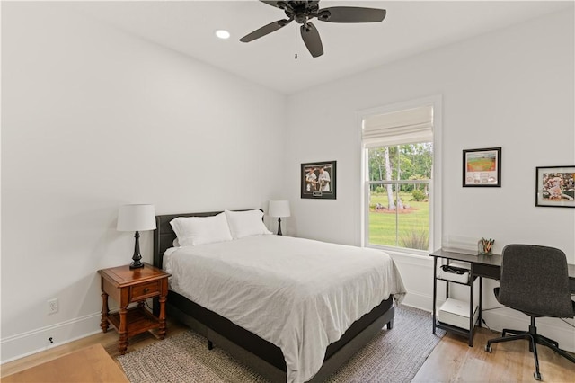 bedroom with baseboards, light wood finished floors, an office area, recessed lighting, and ceiling fan