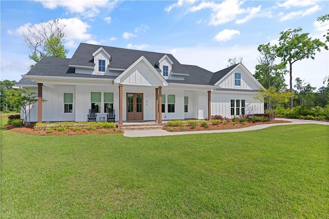 modern farmhouse style home featuring board and batten siding, a front yard, and a porch