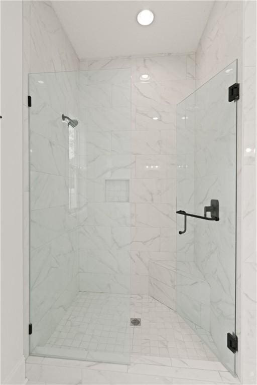 full bath featuring a marble finish shower