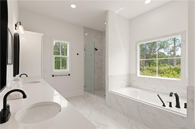 bathroom with recessed lighting, marble finish flooring, a garden tub, a marble finish shower, and double vanity