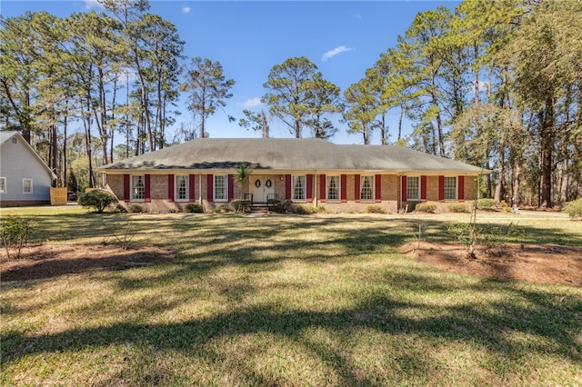 ranch-style house with a front yard and brick siding