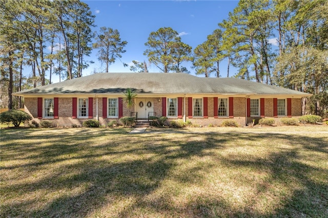 single story home with brick siding and a front yard