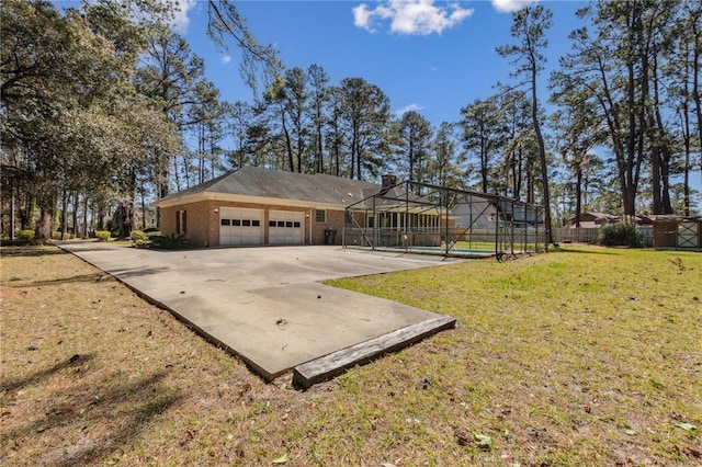 exterior space featuring concrete driveway, an attached garage, a lanai, a front lawn, and brick siding