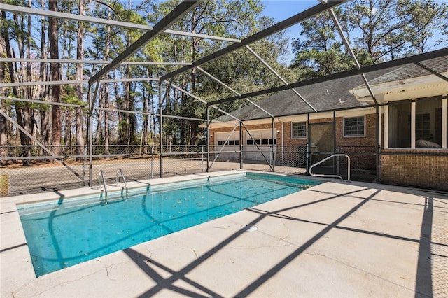 view of swimming pool with glass enclosure, fence, a fenced in pool, and a patio